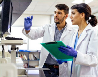 Two Bio-Rad scientists in lab coats reviewing results together at a laboratory workstation